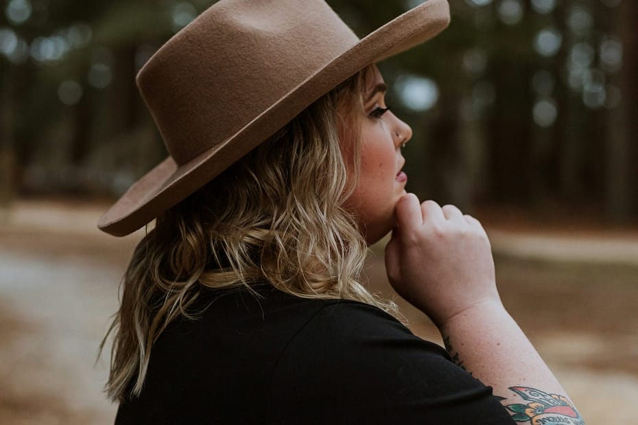 woman in black shirt wearing brown cowboy hat